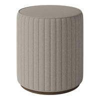Beige textured fabric stool with vertical ribbed pattern and a round wood base. Modern design for versatile decor.