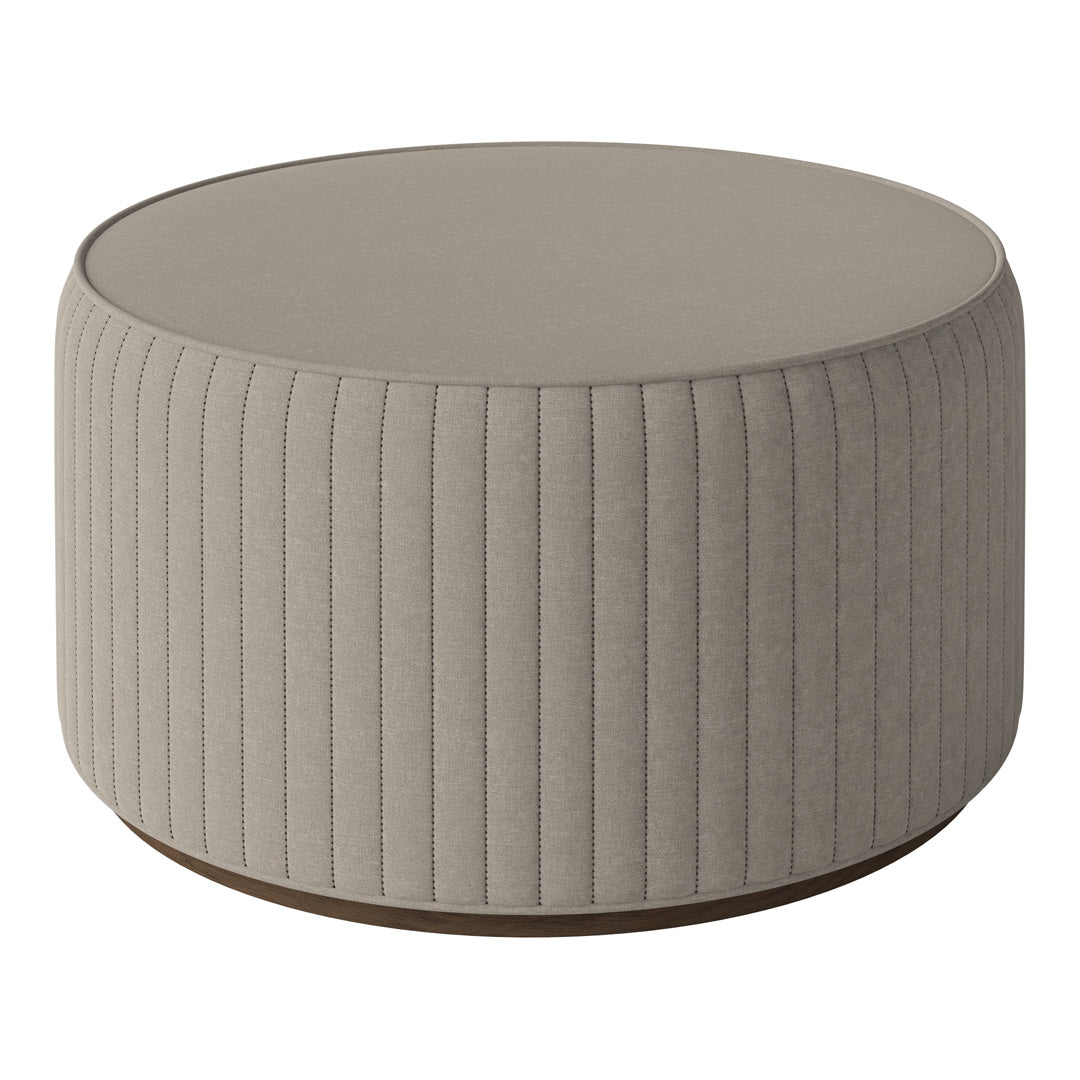 Round beige ottoman with vertical ribbed texture and wooden base, perfect for modern living spaces.