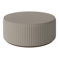 Round coffee table in a soft taupe color with vertical ribbed pattern and smooth circular top. Ideal for modern decor.
