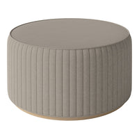 Gray ribbed round ottoman with a smooth top and wooden base. Ideal for modern living spaces.