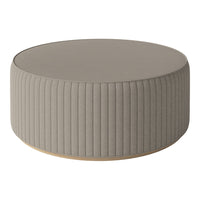 Round taupe ottoman with ribbed texture and a smooth top, perfect for modern decor.