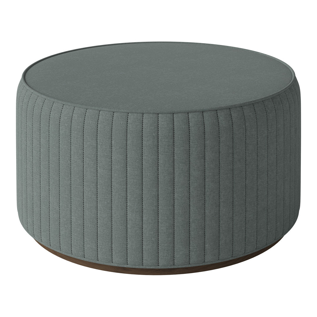 Round tufted pouf in soft gray with vertical ribbed pattern and wooden base, perfect for modern decor.