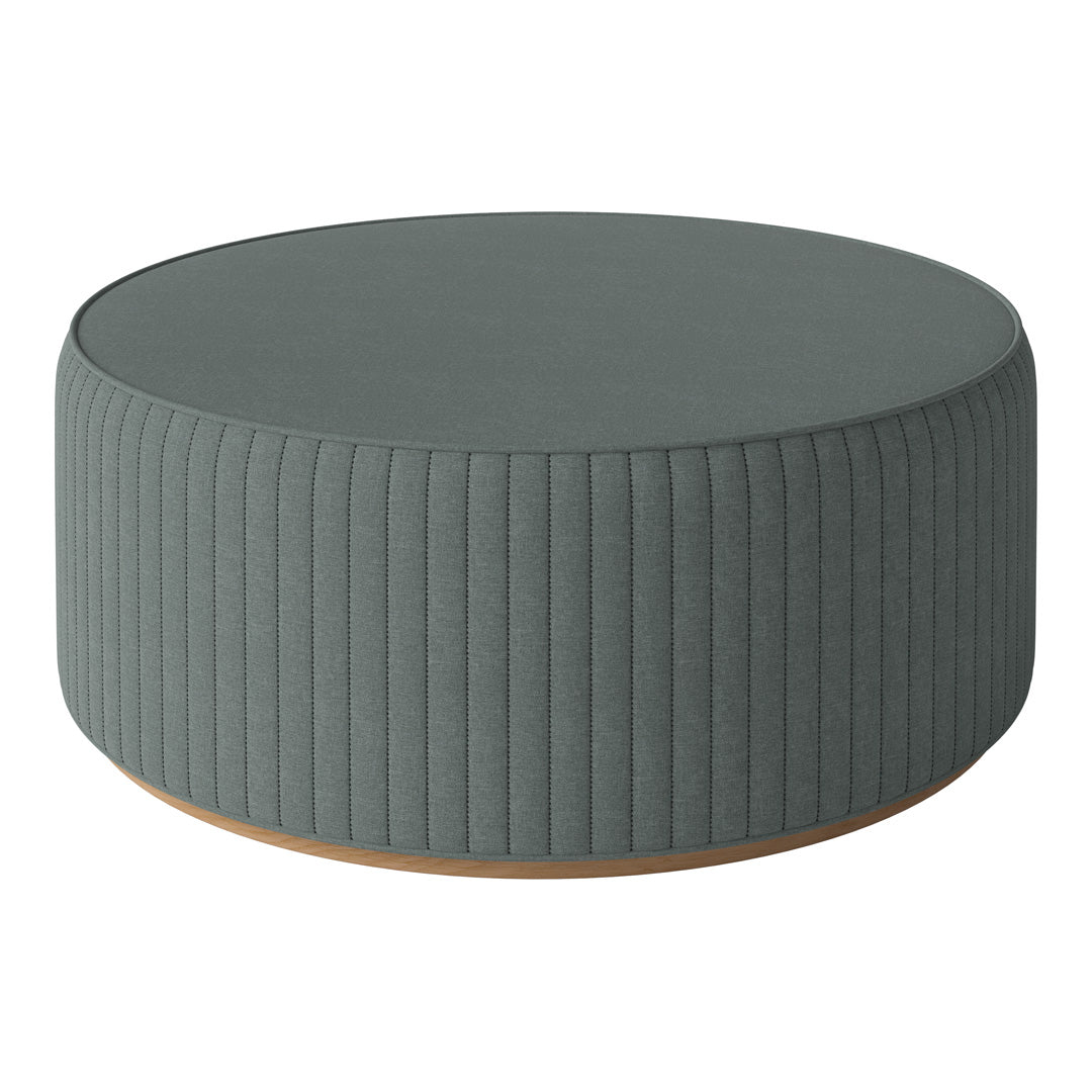 Gray ribbed round ottoman with a smooth top and subtle wooden base, perfect for contemporary decor.