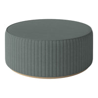 Round green ottoman with vertical ribbed texture and light wood base. Ideal for modern living spaces.