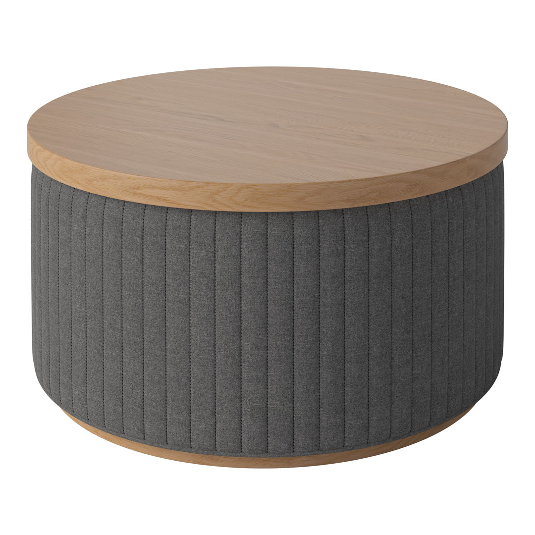 Round coffee table with a natural wood top and textured dark gray vertical ribbed fabric sides. Perfect for modern decor.