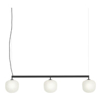 Modern pendant light with three white glass globes and a sleek black frame, perfect for contemporary decor.