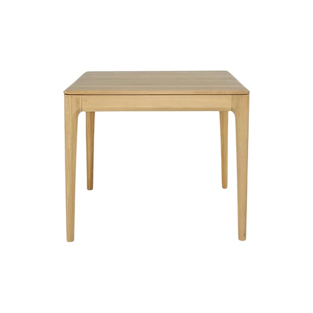 Natural wood finish dining table with a simple, sleek design and subtle grain patterns. Perfect for modern decor.