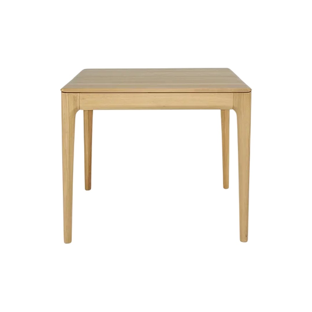 Natural wood dining table with a light, honey-toned finish and sleek, minimalist design.