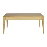 Light oak wood table with a smooth, natural finish and clean lines, perfect for modern decor.