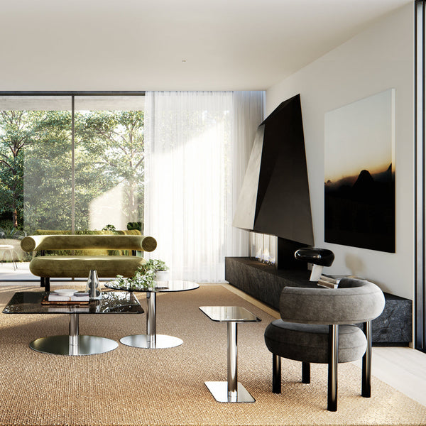 Modern living room featuring olive green and gray furniture, circular glass tables, and textured beige carpet.