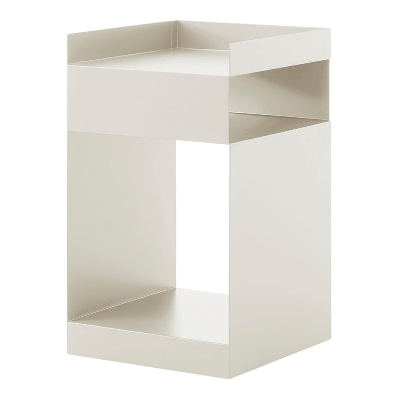 Minimalist white storage stool with a sleek, geometric design and smooth, matte finish, perfect for modern interiors.