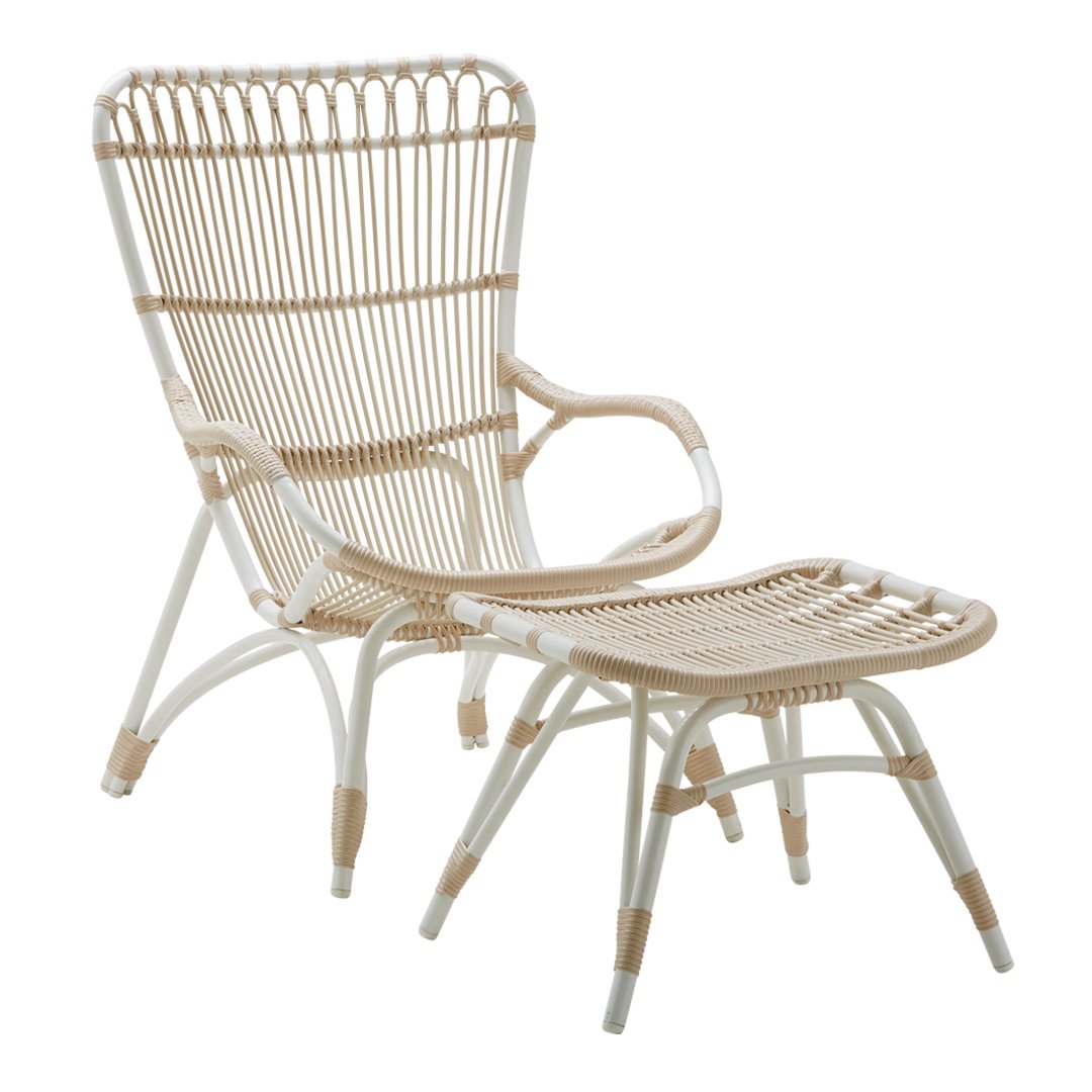 Beige and white woven rattan chair with an elegant, airy design and matching footrest, perfect for a stylish home.