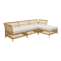 Light-colored fabric cushions with natural woven rattan frame in a minimalist design, perfect for outdoor spaces.