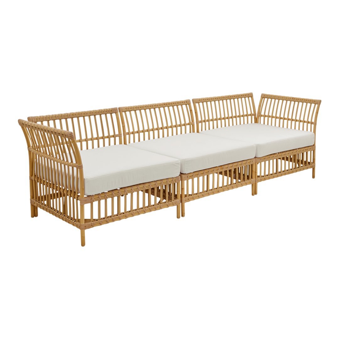 Natural rattan sofa with a light beige cushion, featuring a sleek, modern design and open slat pattern.