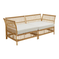Rattan sofa with natural bamboo finish and cream cushions, featuring a slatted design for a modern touch.