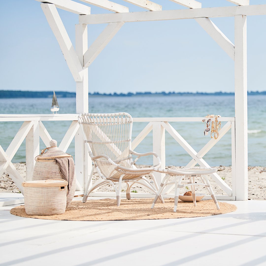 "Coastal decor with neutral tones, natural textures, and a serene beachside backdrop."