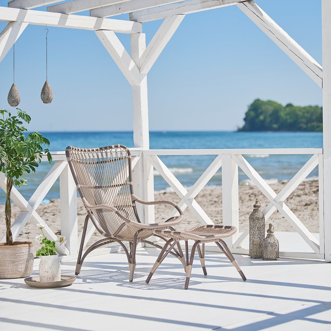 "Relaxing beachside chair set in soft beige and natural tones, featuring a woven pattern and white wooden accents."