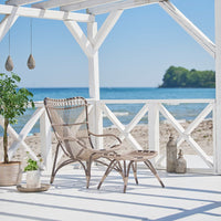 "Relaxing beachside chair set in soft beige and natural tones, featuring a woven pattern and white wooden accents."