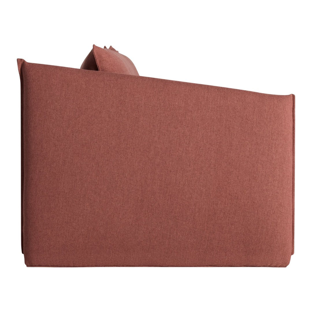 Rust-colored sofa with a soft, textured fabric and minimalist design, perfect for contemporary decor.