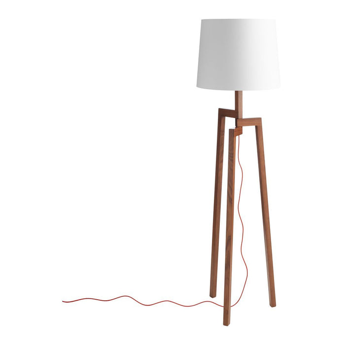 White lampshade, natural wood base, and a vibrant red power cord detail. Modern, stylish design with neutral tones.