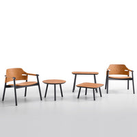Modern wooden chairs and tables in warm honey and sleek black colors, featuring minimalist design and smooth finishes.