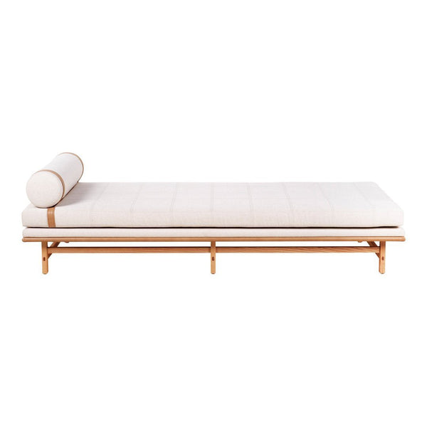 Light beige chaise lounge with a simple design, featuring a cylindrical pillow and natural wood frame.