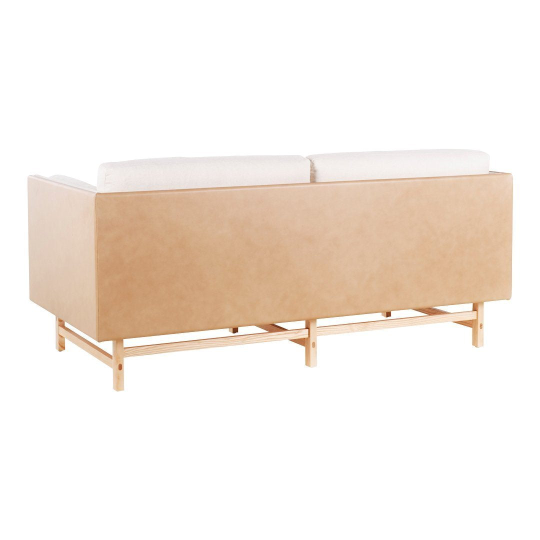 Light beige upholstered sofa with white cushions and a natural wood frame. Minimalist design with smooth textures.