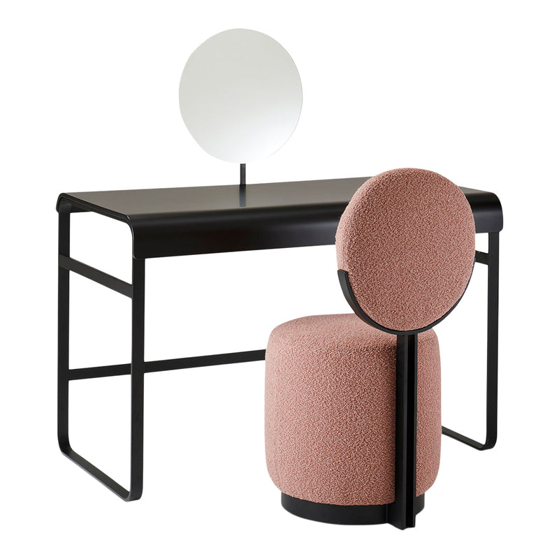 Modern black desk with a round mirror and a soft pink textured chair, featuring a minimalist design and clean lines.