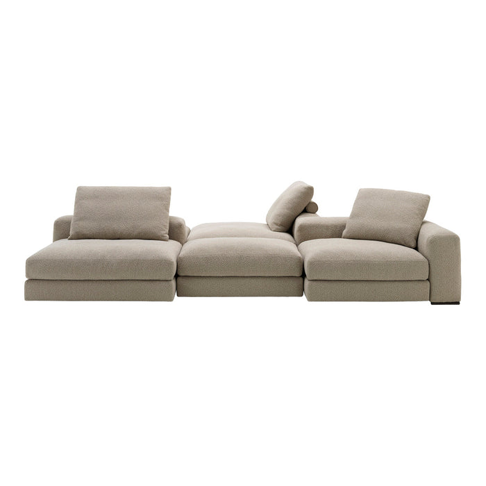 Beige sectional sofa with a smooth texture and minimalist design, featuring plush cushions and subtle, modern lines.