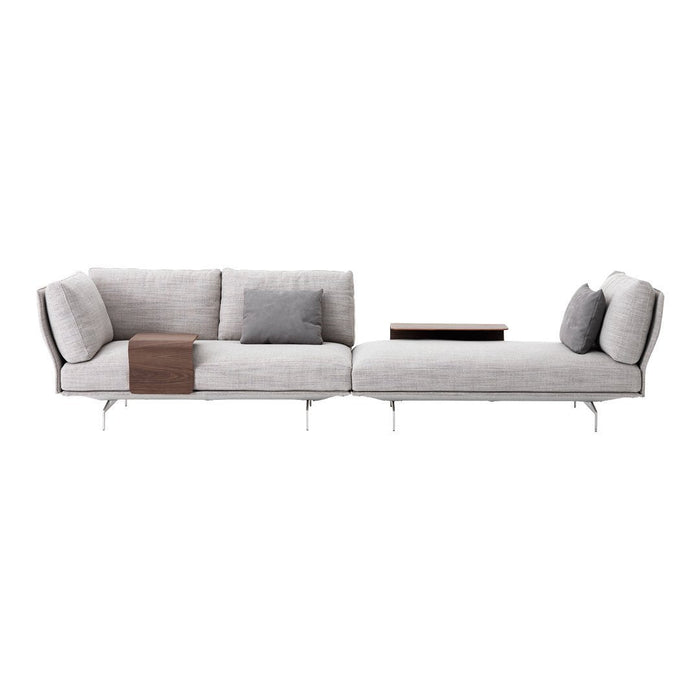 Modern light gray sectional sofa with sleek lines, plush cushions, and minimalistic wooden accent table.