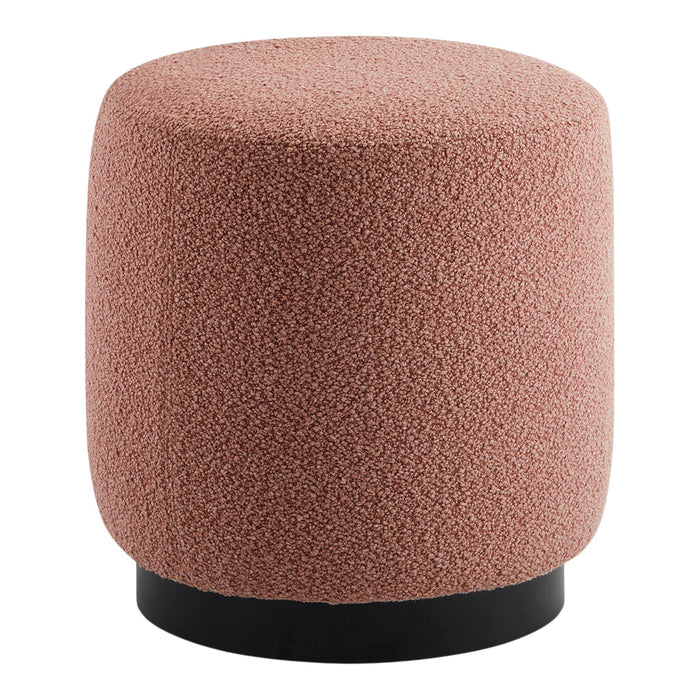 Textured pink pouf with a rounded shape and black base, perfect for modern décor.