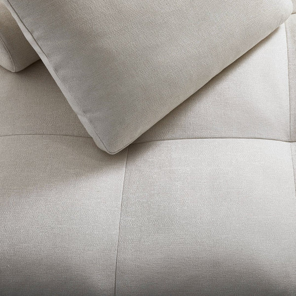 Light beige textured upholstery with smooth and soft surface, featuring a subtle grid pattern.