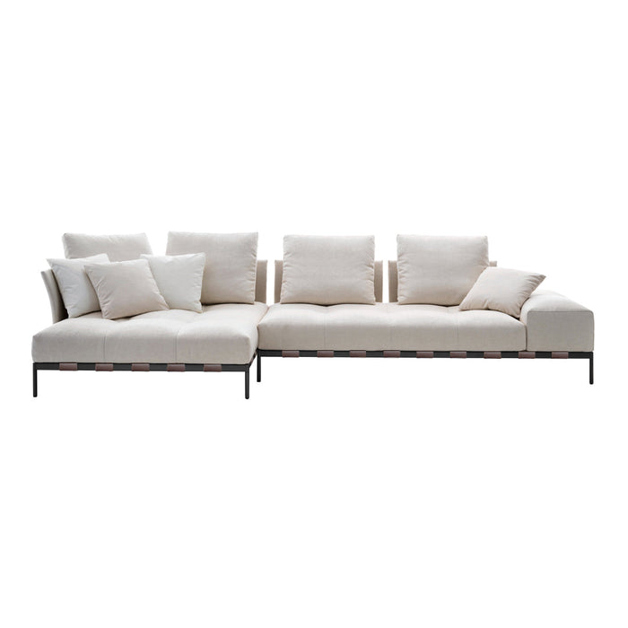 Beige sectional sofa with plush cushions and sleek black metal accents, featuring a minimalist design.