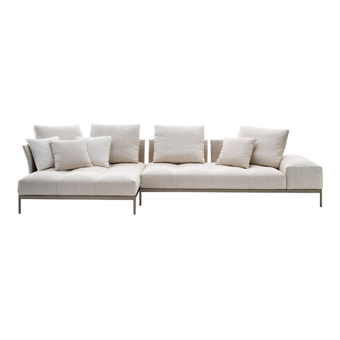 Beige sectional sofa with plush pillows, featuring a minimalist design and soft, textured fabric. Perfect for modern interiors.