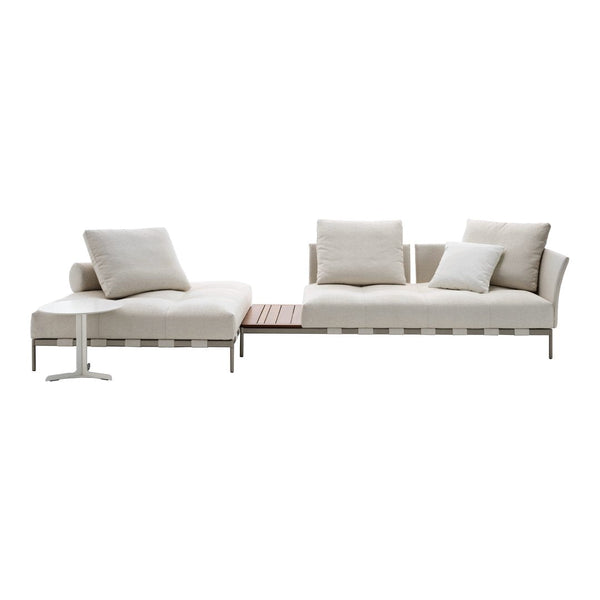 Modern beige sectional sofa with soft cushions and sleek metal accents; minimalistic design ideal for contemporary decor.