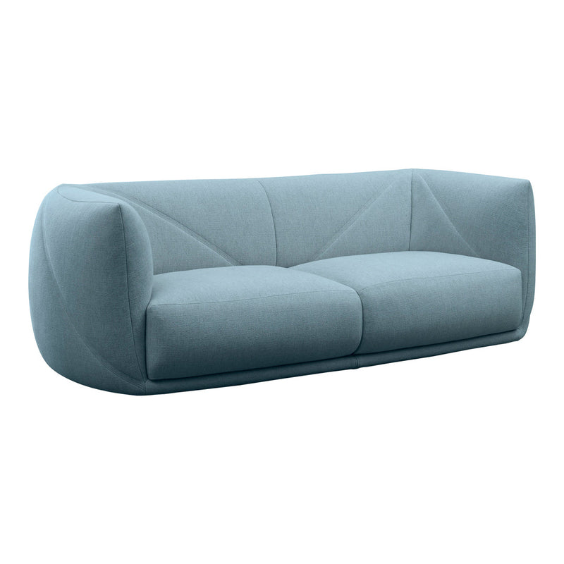 Soft blue fabric sofa with a modern, sculptural shape and geometric stitching pattern. Ideal for contemporary interiors.