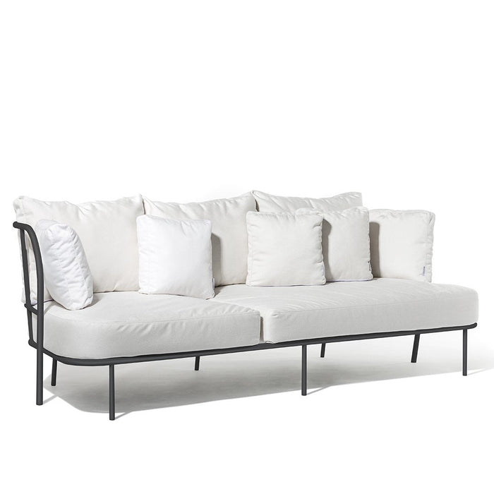 Elegant white sofa with plush cushions and sleek black metal frame, featuring a minimalist design and contemporary style.