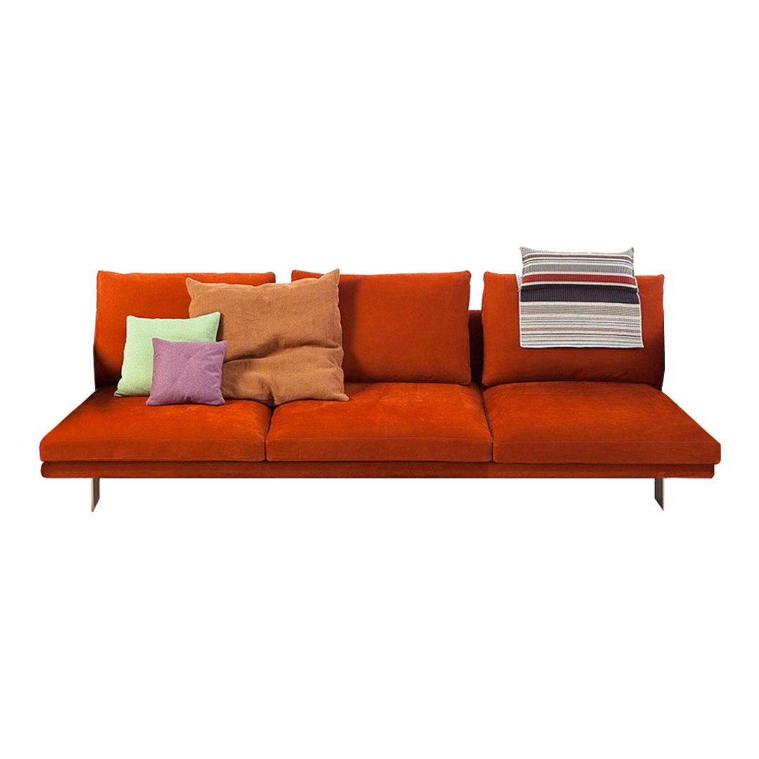 Vibrant orange sofa with colorful throw pillows in green, purple, and striped patterns, ideal for modern decor.