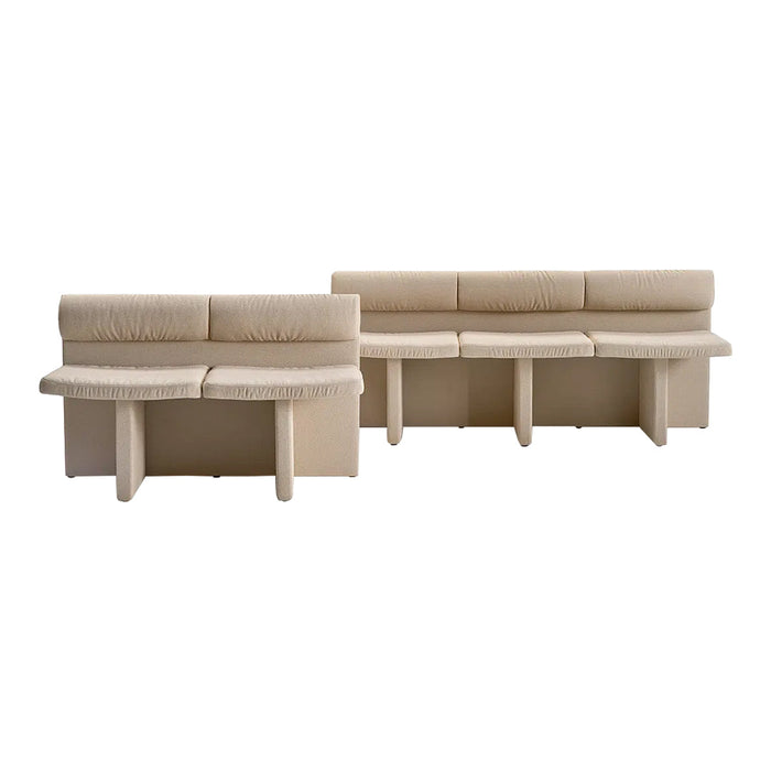Beige upholstered sofa set with textured fabric and minimalist design, featuring clean lines and simple shapes.
