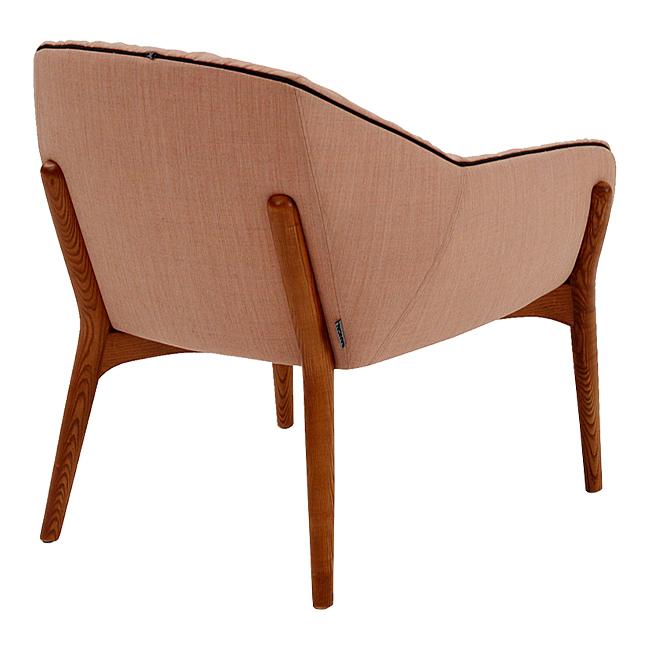 Mid-century modern chair in soft pink fabric with dark wood legs and clean, minimalist lines.