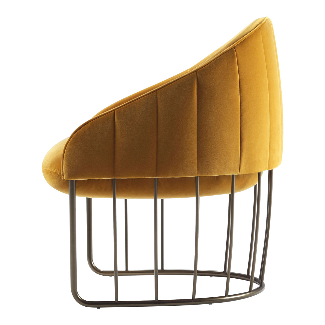 "Curved mustard yellow velvet chair with ribbed detailing and metal frame, perfect for modern interiors."