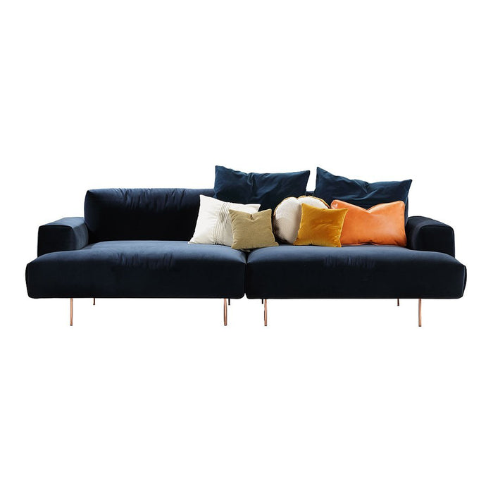 Stylish navy blue sofa with mixed colorful cushions: cream, yellow, orange, and textured patterns. Perfect for modern decor.