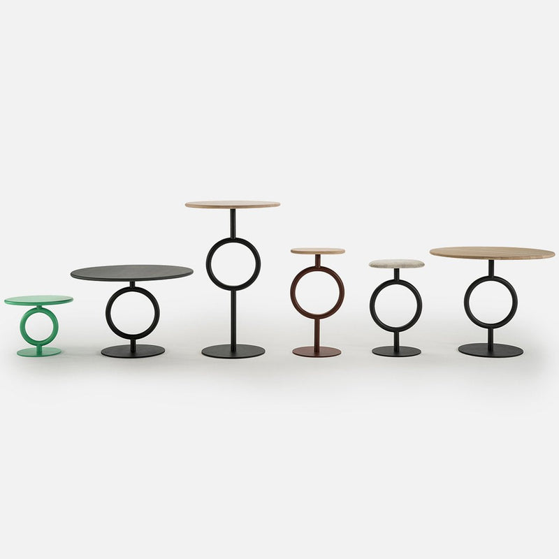 Colorful modern side tables featuring black, green, brown, and natural wood finishes with circular patterns.