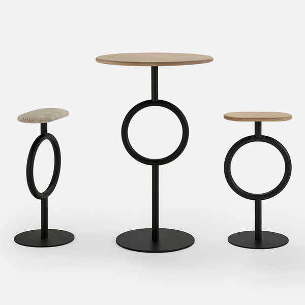 Three modern side tables featuring a light wood finish and black metal bases with circular designs.