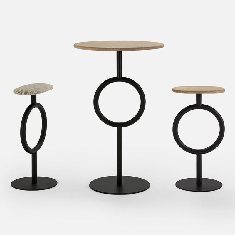 Three modern side tables featuring a light wood finish and black metal bases with circular designs.
