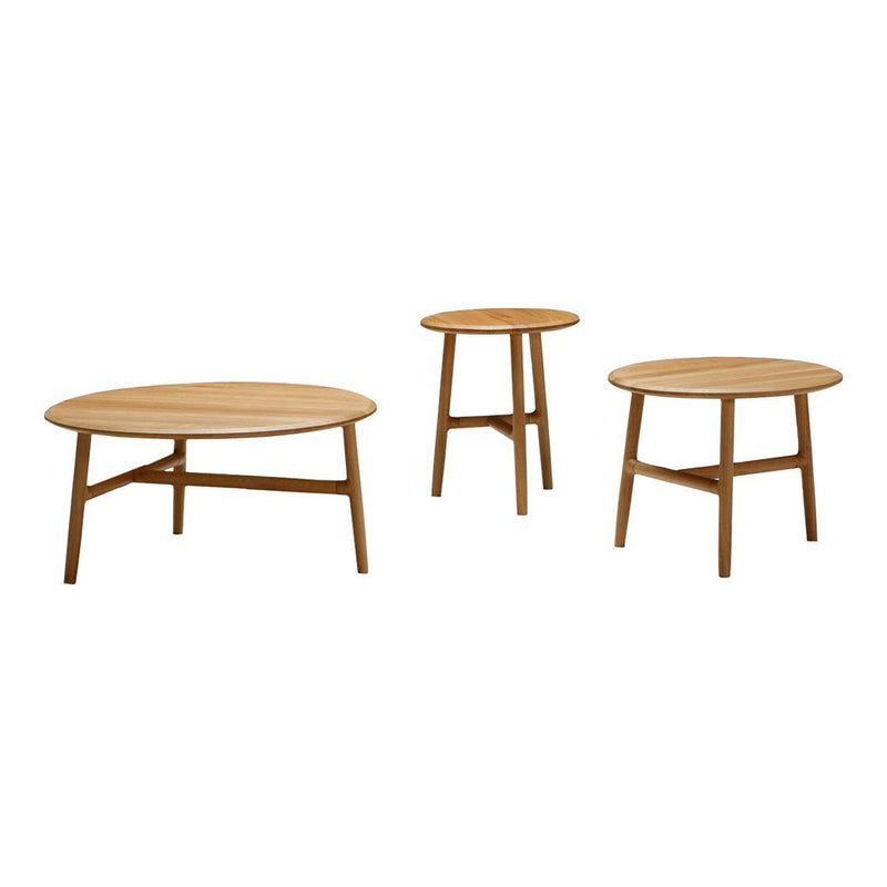 Set of three wooden tables in natural oak finish, featuring smooth surfaces and simple, modern designs.