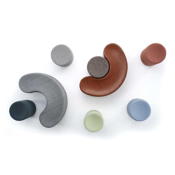 Colorful geometric shapes in gray, brown, green, blue, and terracotta with smooth patterns on a white background.