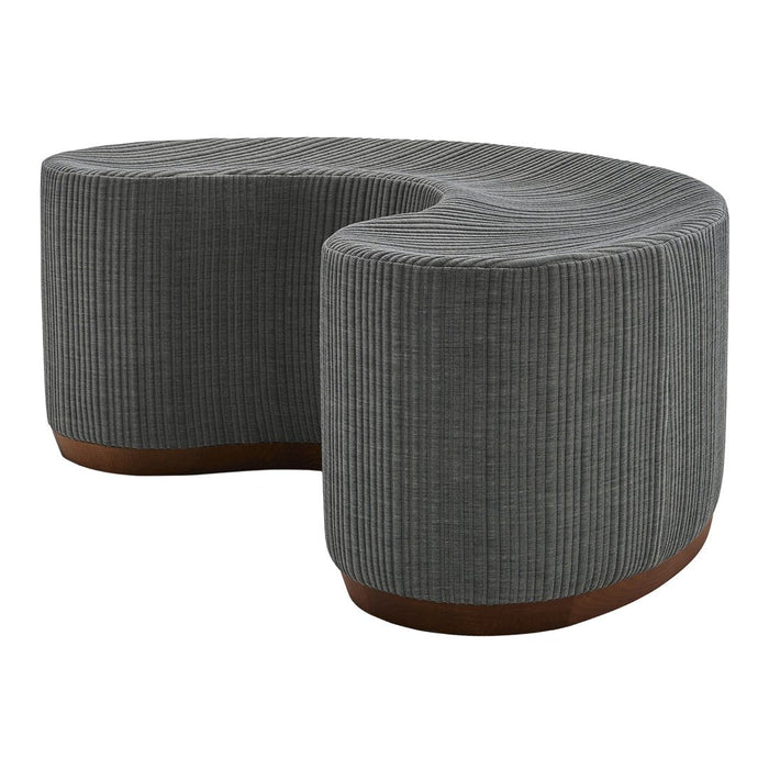 Curved gray bench with a textured, ribbed pattern and a warm brown base. Stylish and modern accent piece.