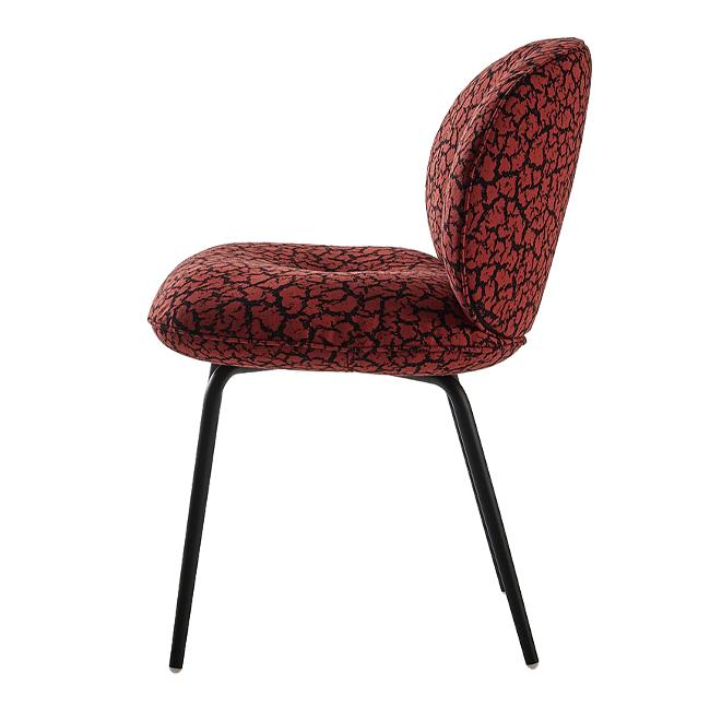 Red chair with black abstract pattern on plush fabric and sleek black legs, perfect for modern decor.