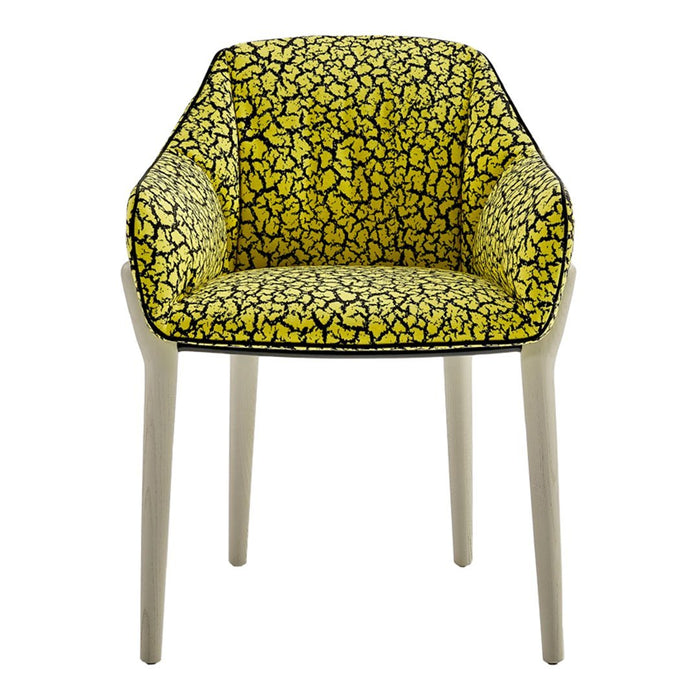 Chic armchair with a vibrant yellow pattern and black abstract designs on a light-colored frame. Ideal for bold decor.